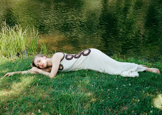Woman in white dress by the water