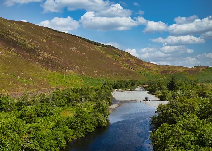 Scenic River Valley with Vehicle