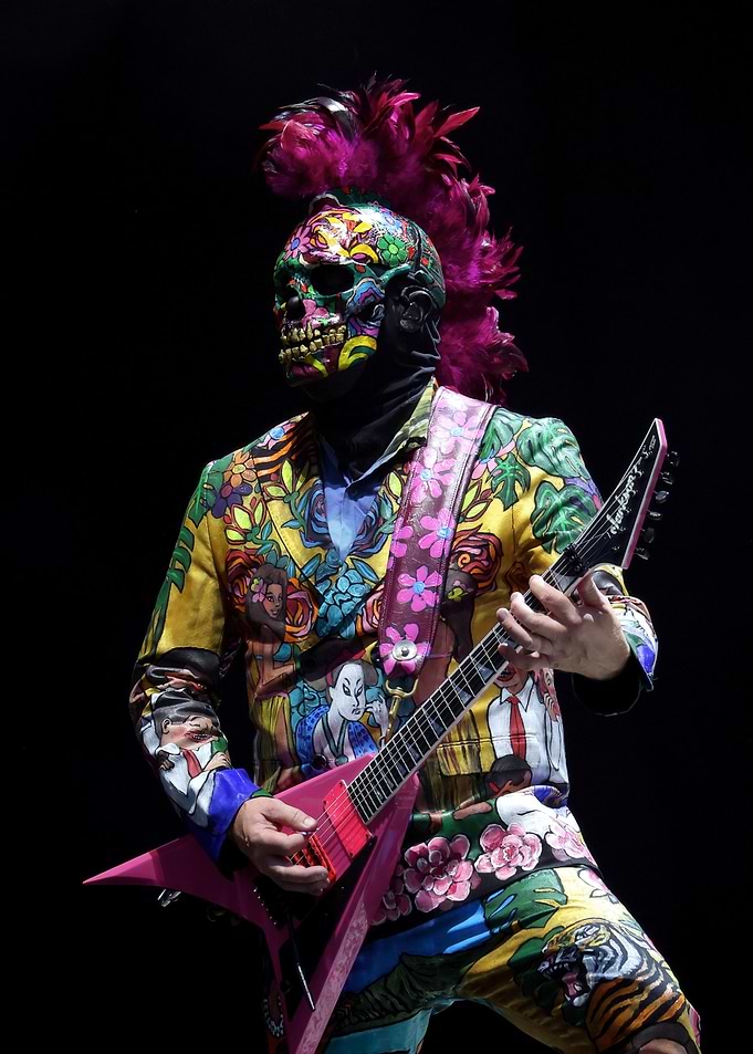 Musician in Skull Mask and Colorful Outfit