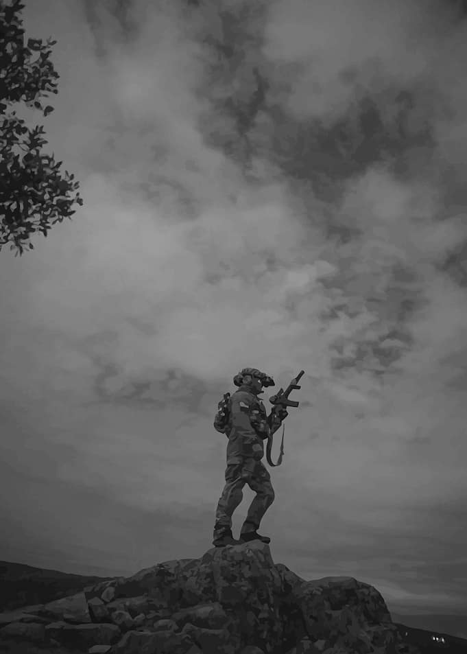 Soldier on a rocky outcrop
