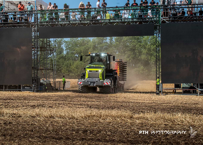 Claas Xerion in a Field with Spectators