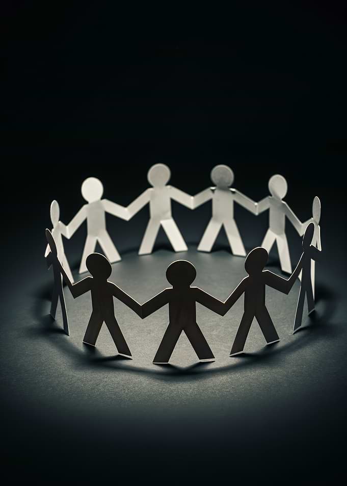 Paper people holding hands in a circle