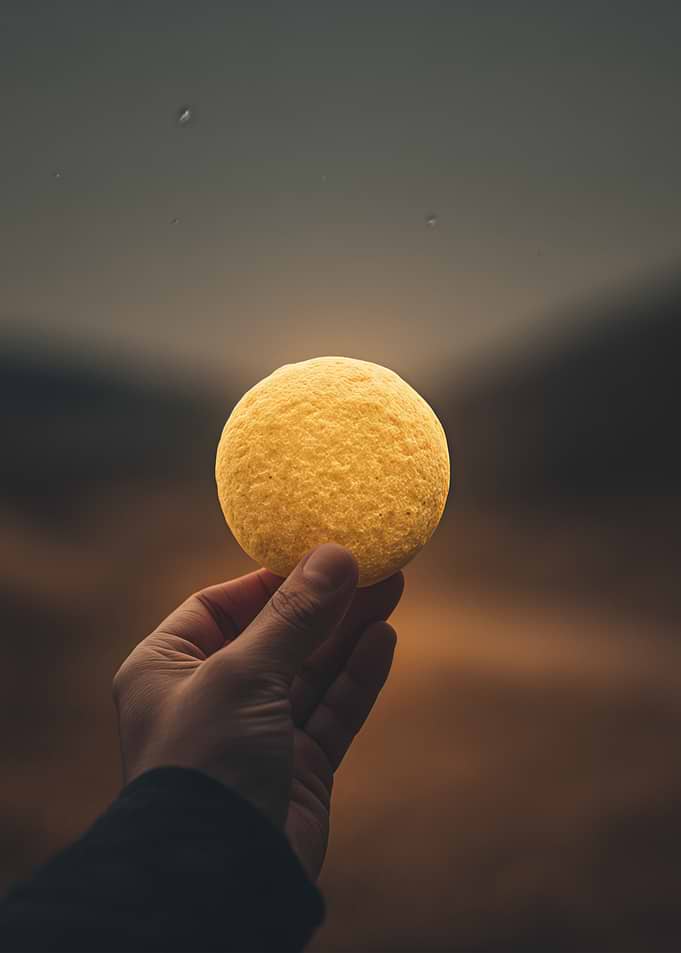 Hand Holding Glowing Yellow Sphere