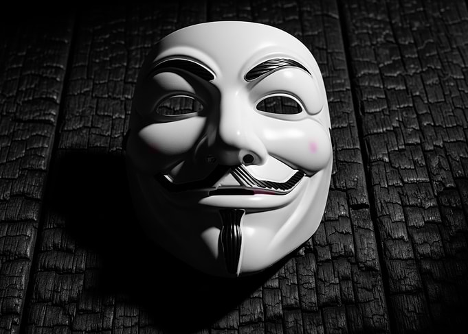 Guy Fawkes Mask on Burnt Wood