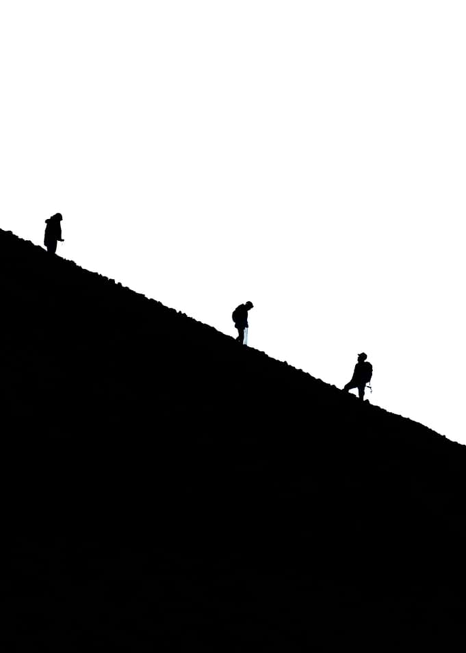 Hikers on a steep mountain slope