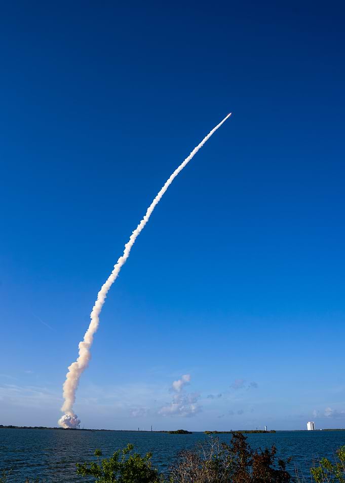Rocket Launch Trail Against Blue Sky