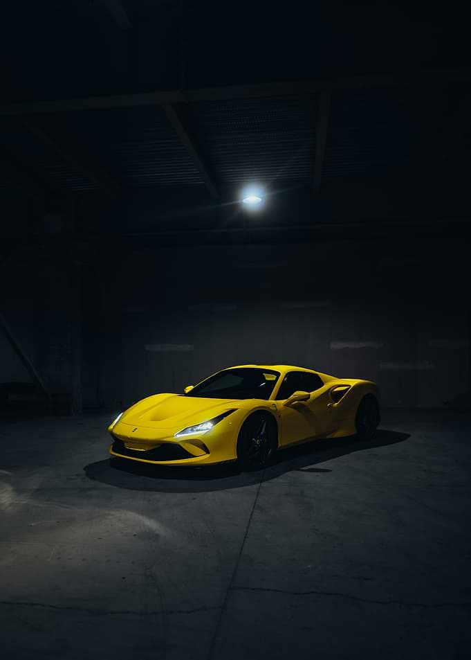 Yellow Ferrari F8 Tributo in Dark Garage