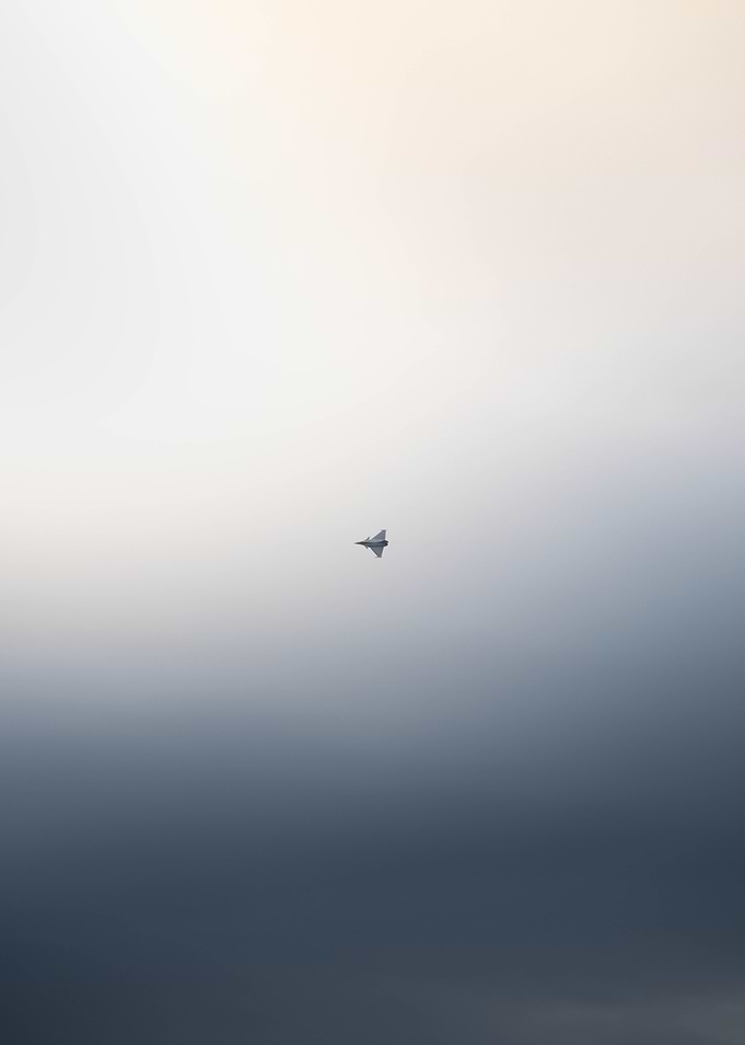 Fighter Jet in a Misty Sky