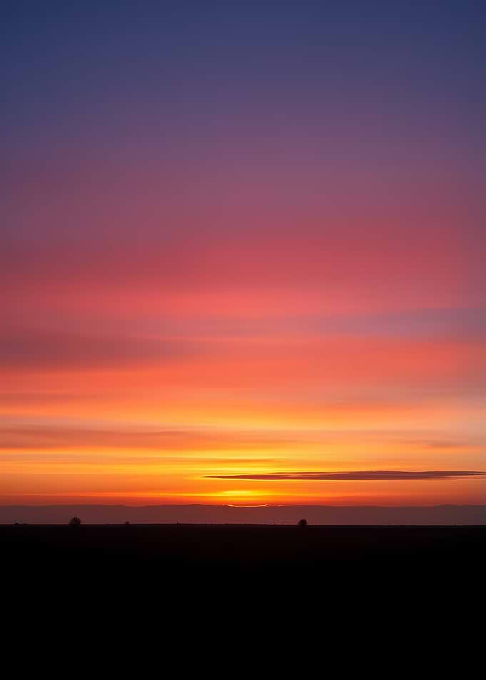 Vibrant Sunset Over a Dark Horizon