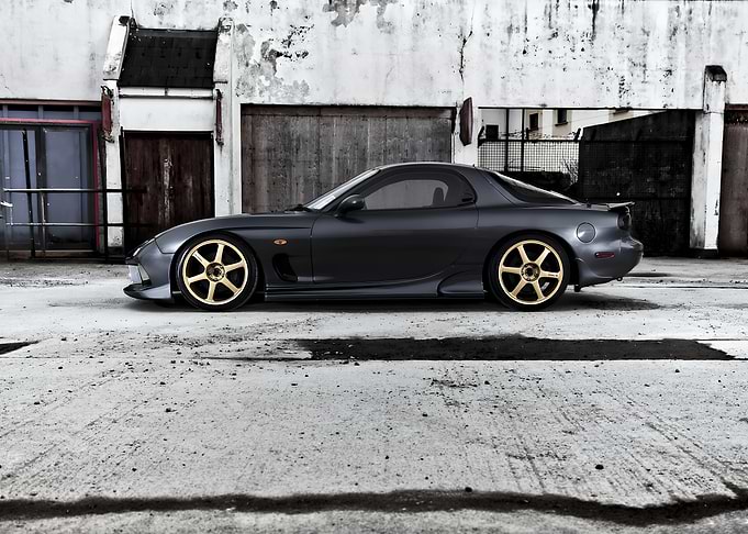 Dark Grey Mazda RX-7 with Gold Wheels