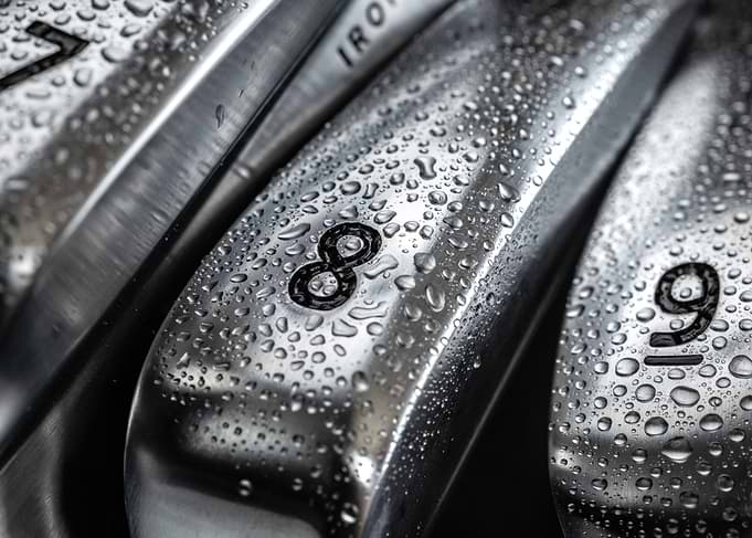Golf Irons with Water Droplets Close-up