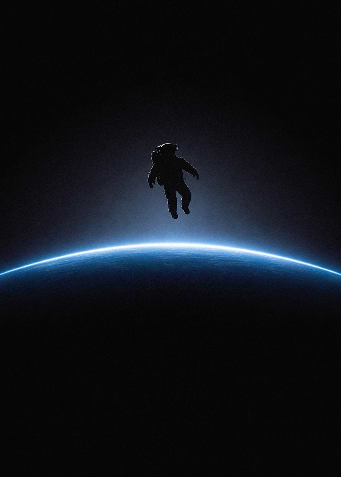 Astronaut floating above planet