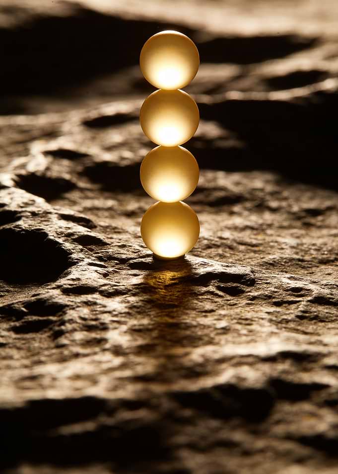 Stacked Glowing Spheres on Textured Surface