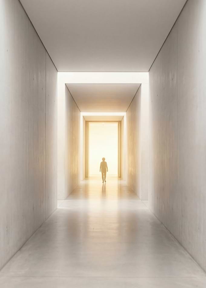 Person walking towards bright light in hallway