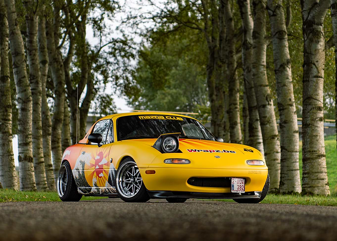 Yellow Mazda Miata with Japanese Art