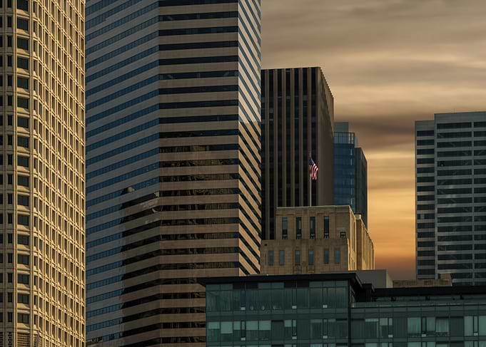 Cityscape with American Flag at Sunset