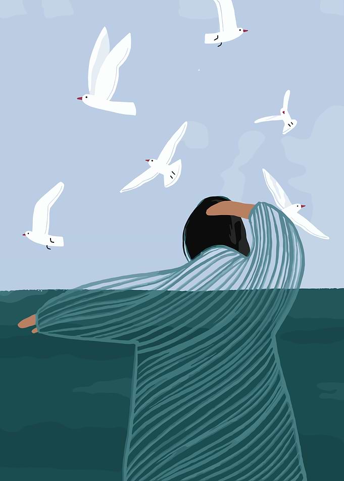 Person with arms outstretched among seagulls