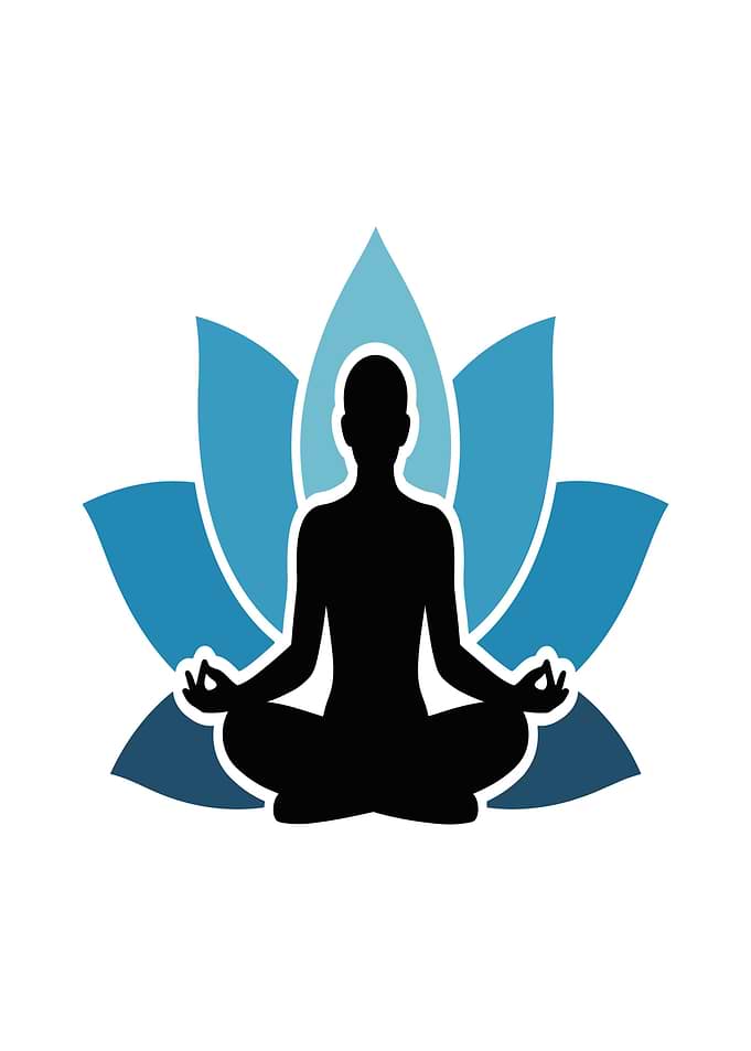 Silhouette of person meditating in lotus pose