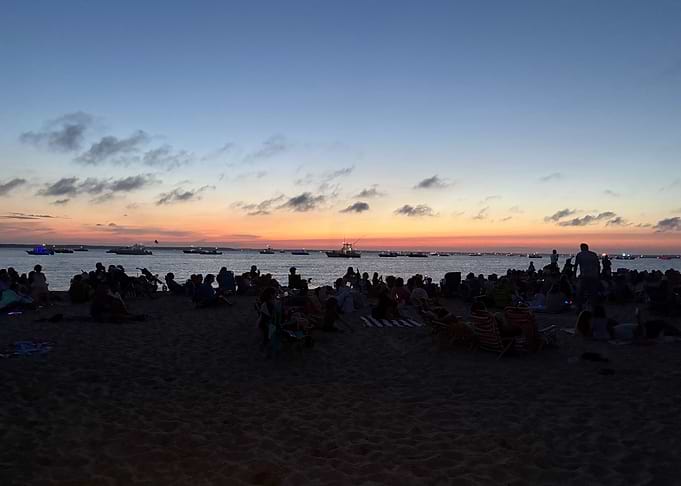 Sunset Beach Gathering with Boats