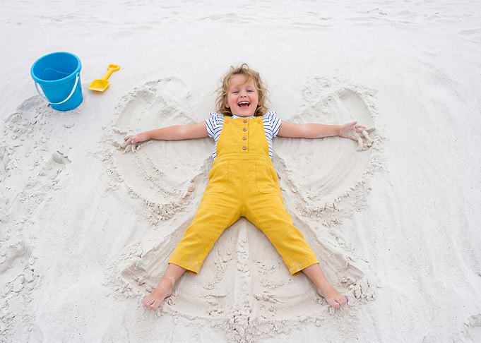Girl Making a Sand Angel