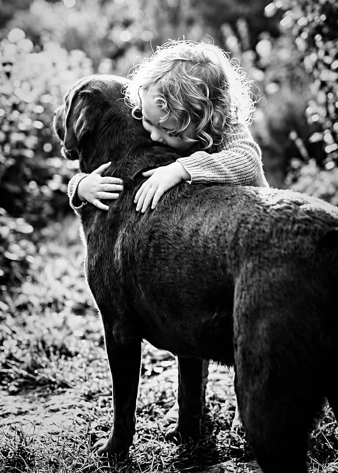 Child hugging a dog
