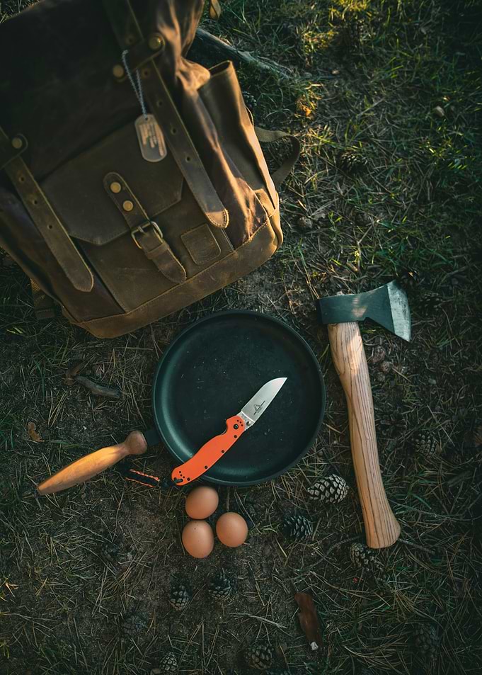 Camping cooking setup with backpack and axe
