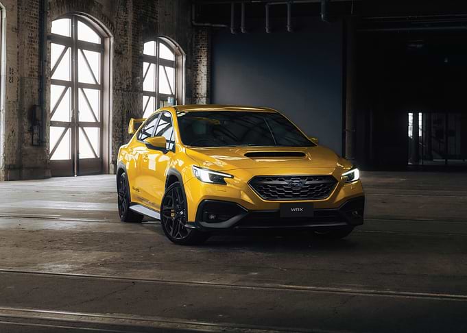 Yellow Subaru WRX in Industrial Setting