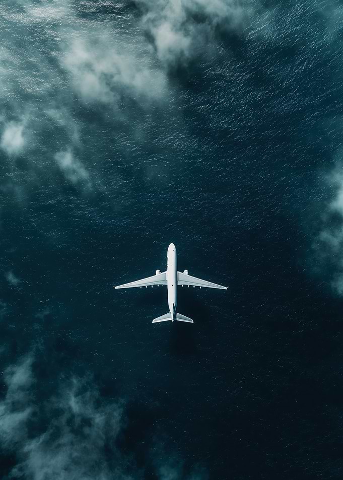 Airplane flying over the ocean