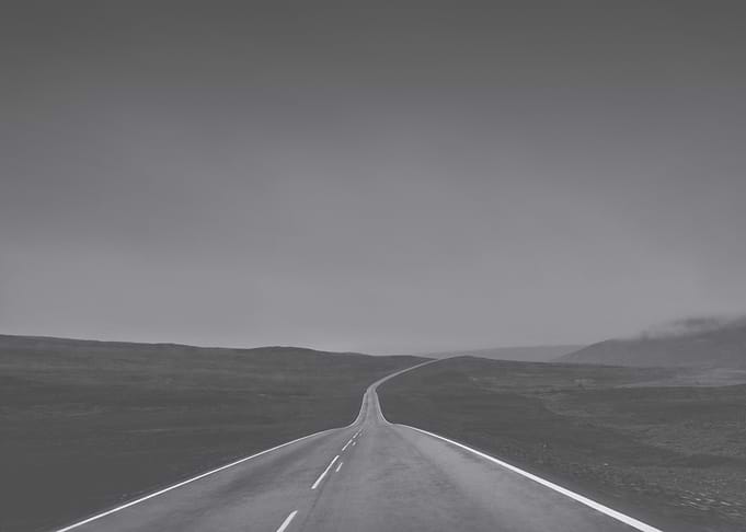 Empty Road Through Barren Landscape