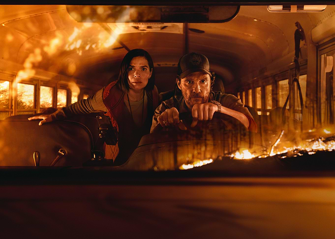 Bus on fire with two people