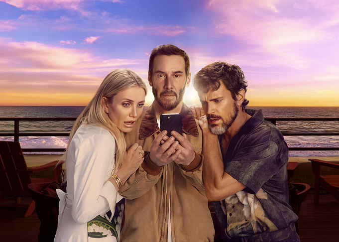 Three people looking at a phone