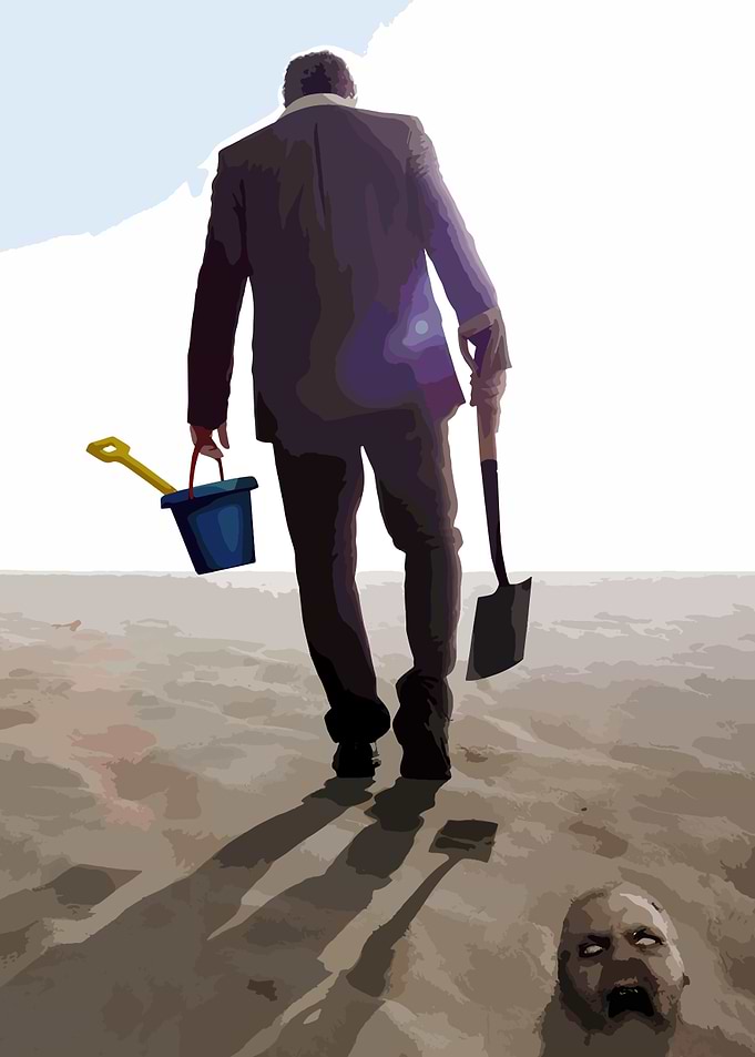 Man with shovel and bucket on beach