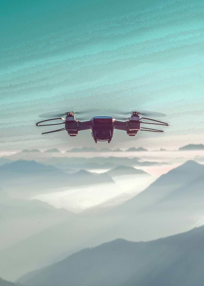 Drone flying over misty mountains
