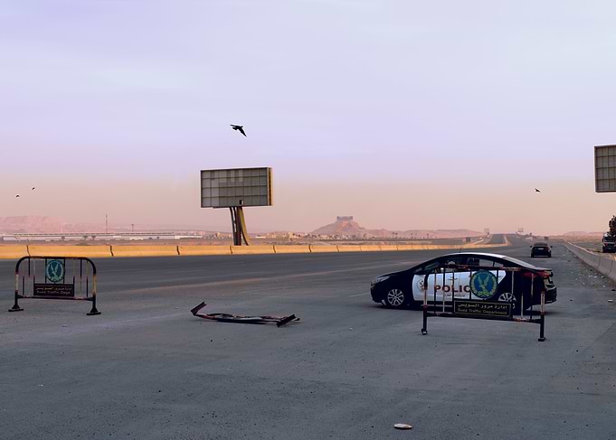 Police car at a road checkpoint
