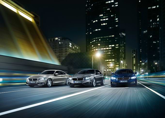 BMW Cars Driving at Night in City