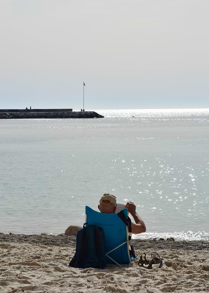 Man Relaxing on Beach by the Sea