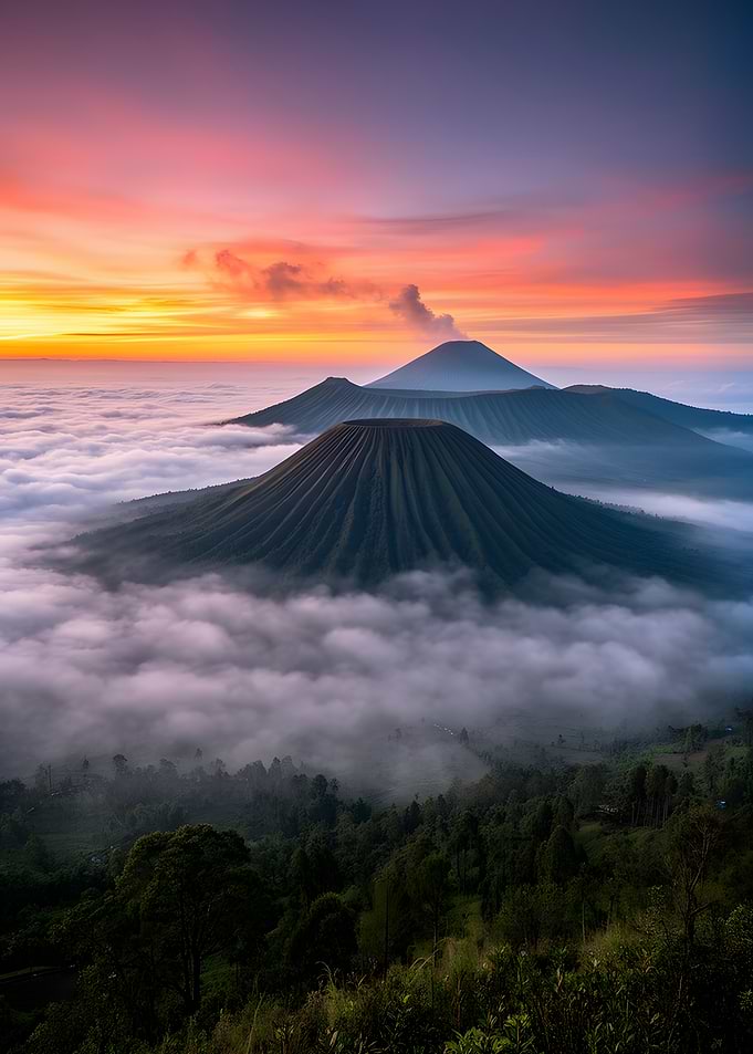 Volcanoes Erupting Above Clouds at Sunrise