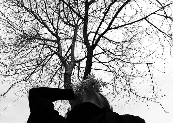 Woman with Flowers Under Tree
