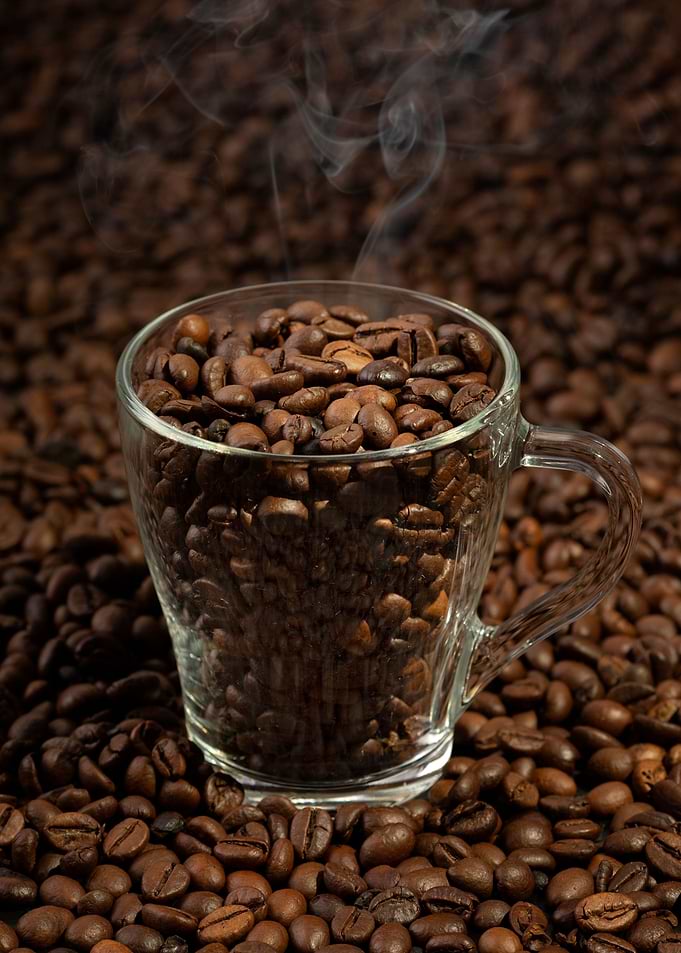 Steaming Coffee Beans in a Glass Cup