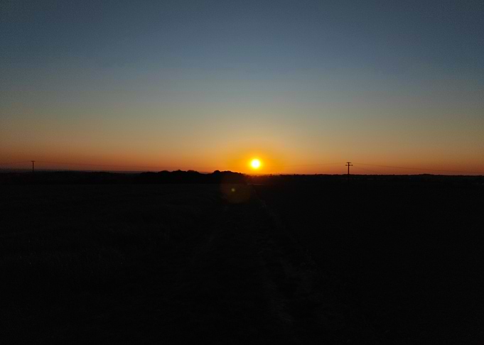 Sunset over a dark landscape