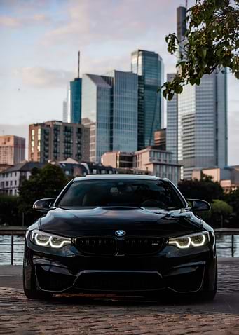 Black BMW M4 in Cityscape