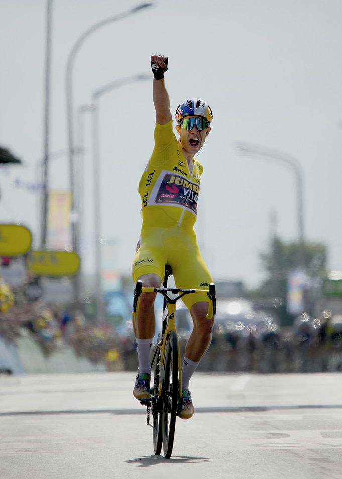 Cyclist in Yellow Jersey Celebrates Victory