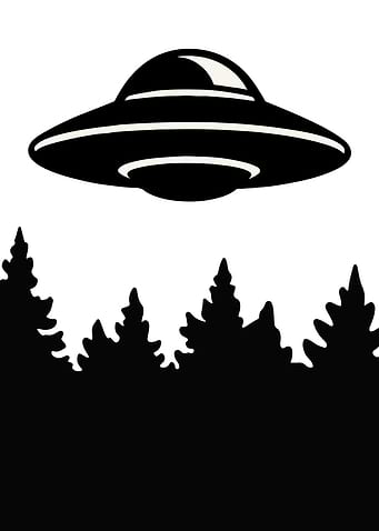 UFO Hovers Over a Forest in silhouette