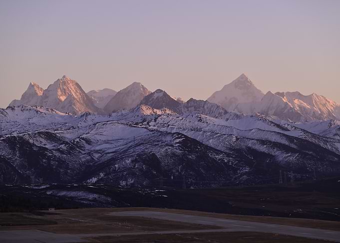 Snow-capped mountains at sunset