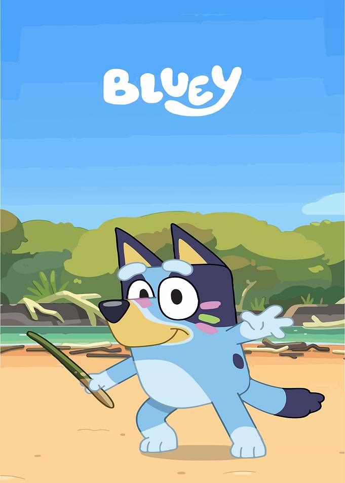 Bluey holding a stick on the beach