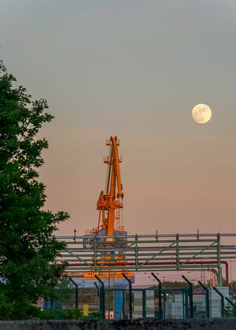 Industrial Crane and Moon at Dusk