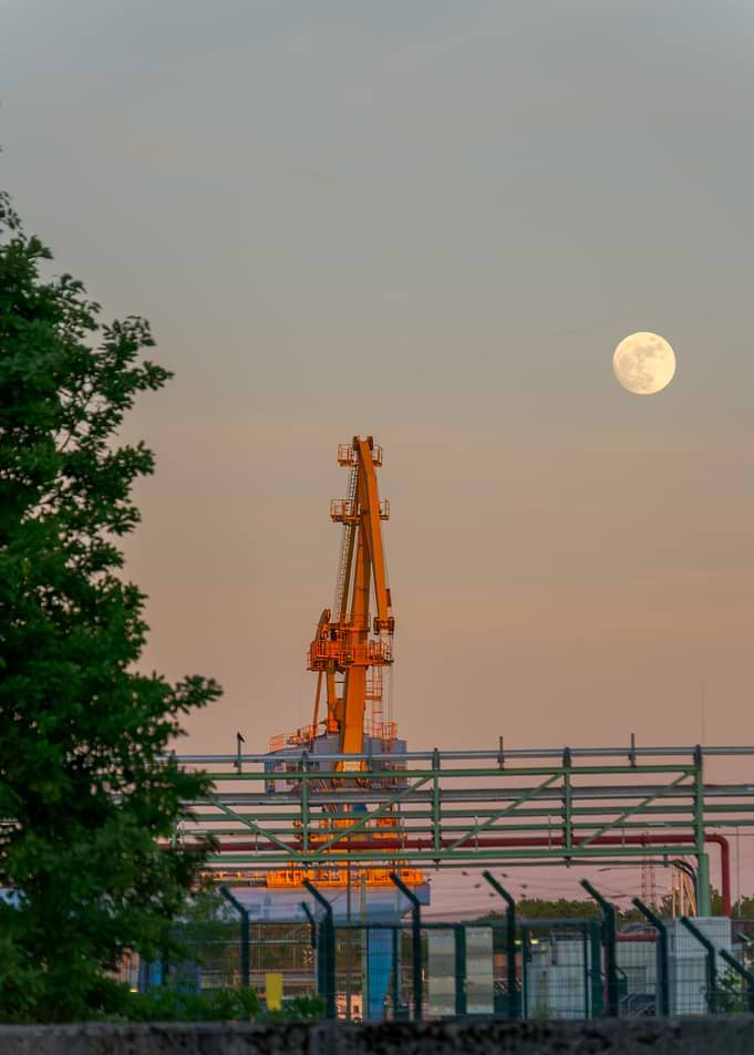 Industrial Crane and Moon at Dusk