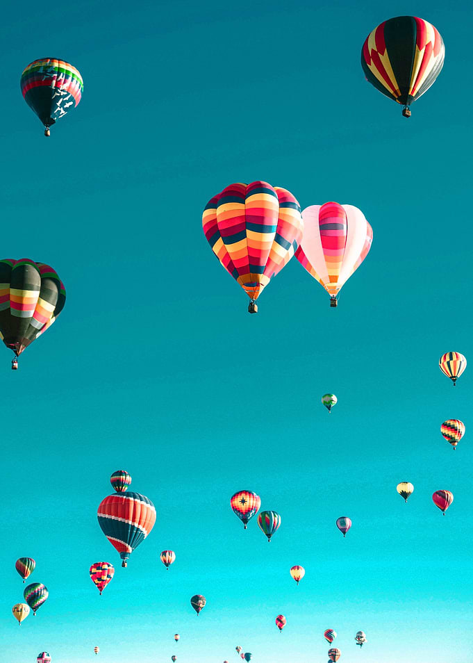 Hot Air Balloons Ascending in Blue Sky