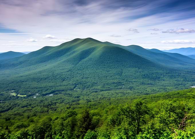 Verdant Mountain Landscape Under Cloudy Sky