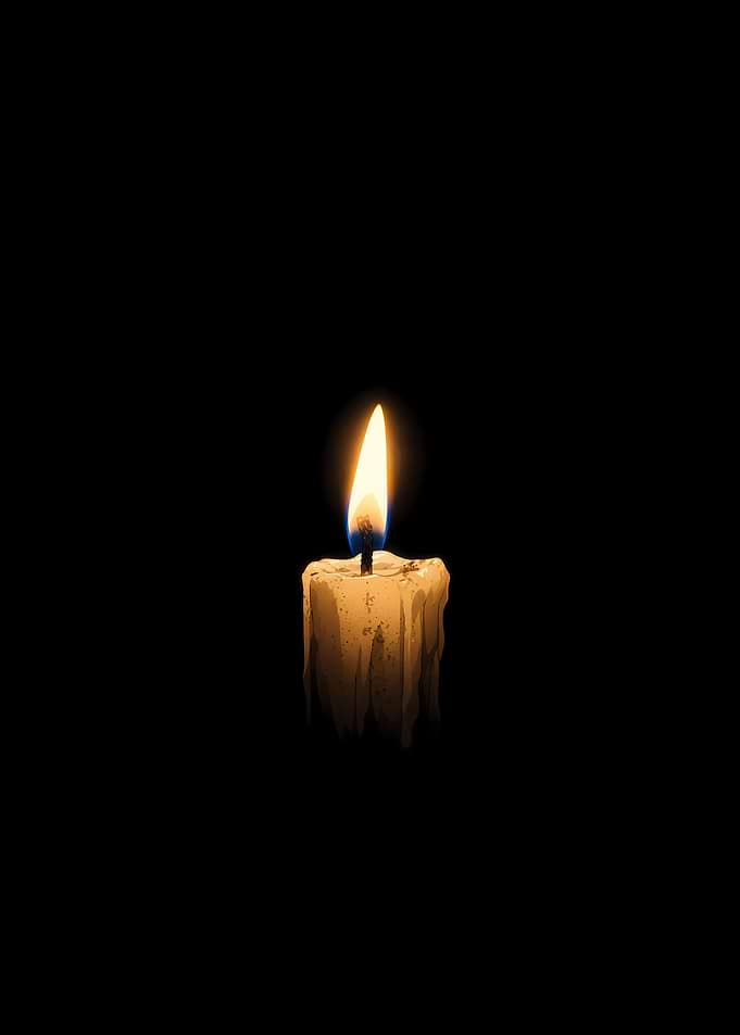 Single Lit Candle in Darkness